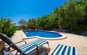 a swimming pool with two lounge chairs next to it at Sos Monjos in Artá