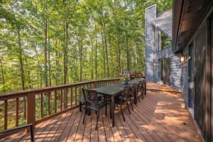 a wooden deck with a table and chairs on it at Black Bear Lodge by Railey Vacations in Oakland