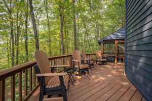 a deck with chairs and a gazebo in the woods at Black Bear Lodge by Railey Vacations in Oakland