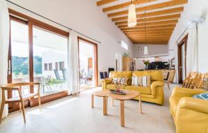 a living room with a yellow couch and a table at Amedart in Alcudia