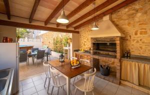 an open kitchen and dining room with a table and chairs at Casa Hermosa in Capdepera +34 photos