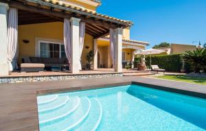 a swimming pool in front of a house at Montelago in Alcudia