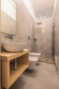 a bathroom with a sink and a toilet at Casa Boutique Mareluna - Luxury Apartments by Mareluna Hotel in Salerno +45 photos