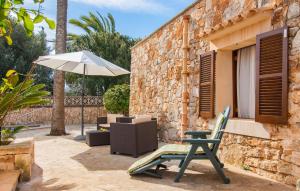 a patio with a chair and an umbrella at Moli De Ca N'orell in Santanyi +39 photos