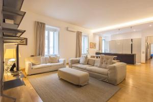 a living room with two couches and a table at Casa Boutique Mareluna - Luxury Apartments by Mareluna Hotel in Salerno