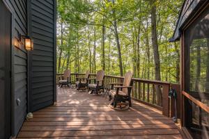 a porch with rocking chairs and trees on a house at Black Bear Lodge by Railey Vacations in Oakland