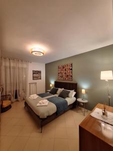a bedroom with a large bed and a table at La Terrazza in Noicattaro +17 photos