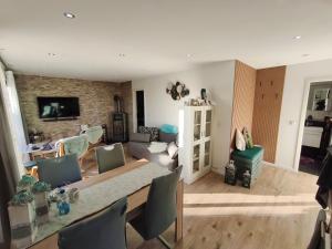 a living room with a table and a couch at Ferienhaus Leon mit Sauna in Rehburg-Loccum