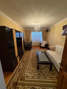 a living room with a couch and a table at Lankaran house in Lankaran