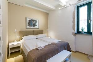 a bedroom with a bed with two towels on it at Tre Porte Rooms & Bar in Rovinj +61 photos