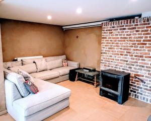 a living room with a couch and a fireplace at Au coeur de l'Ardenne - Peaceful loft in Baelen