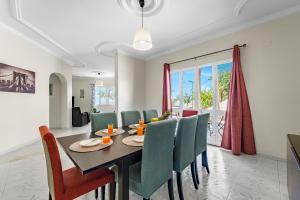 a dining room with a table and chairs at Cumbres Villa in Funchal