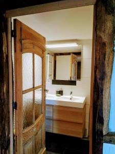a bathroom with a sink and a mirror at Au coeur de l'Ardenne - Peaceful loft in Baelen +19 photos