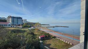 a view of a beach with buildings and the ocean at QUEEN PALACE HOTEL TRABZON in Trabzon
