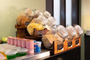 a buffet with some food in jars on a counter at Slim Hotel São Paulo Congonhas in São Paulo