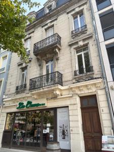 a building with a store in front of it at Le Grand Briand - Champ de Mars in Valence