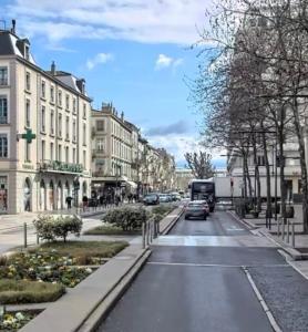 a city street with cars driving down the street at Le Grand Briand - Champ de Mars in Valence
