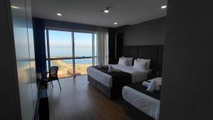 a hotel room with two beds and a large window at QUEEN PALACE HOTEL TRABZON in Trabzon +61 photos