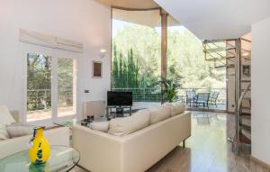 a living room with a white couch and a glass table at Cocodrilo in Alcudia