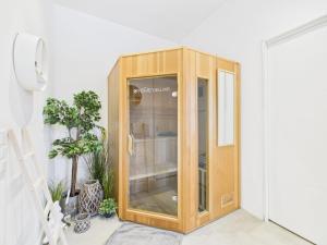 a wooden cabinet in a room with plants at Sam's Cottage Suite in Niederweis