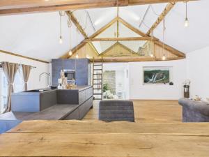 a kitchen with a large wooden table in a room at Sam's Cottage Suite in Niederweis