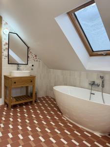 a bathroom with a large white tub and a sink at Sielski Dom in Suwałki +25 photos