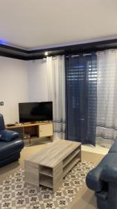 a living room with a couch and a coffee table at Casa Chiquinha in Ribeira da Prata