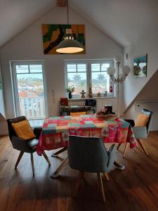 a living room with a table with chairs and a dining room at FeWoSchwedenhaus in Gleiszellen-Gleishorbach