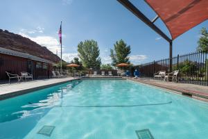 a large swimming pool with blue water at Sun Outdoors Arches Gateway in Moab