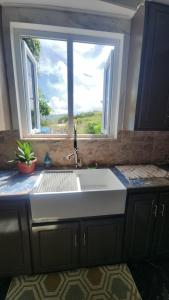 a kitchen with a sink and a window at Hilltop Villa Chez Coco in Rodney Bay Village +24 photos