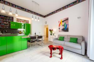 a kitchen and living room with green cabinets and a couch at InLuce Terrazza in Sanremo