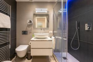 a bathroom with a sink and a toilet and a shower at InLuce Terrazza in Sanremo +48 photos