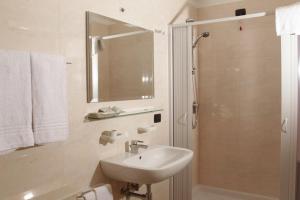 a white bathroom with a sink and a shower at Hotel Club Bellavista in Vieste