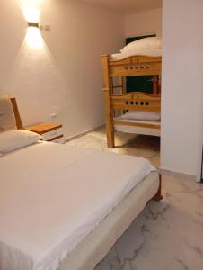 a bedroom with two bunk beds and a lamp at Hotel Santa Ana in Baranoa