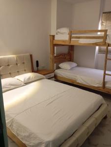 a room with two bunk beds in it at Hotel Santa Ana in Baranoa