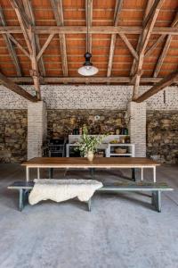 a large room with a wooden table and a bench at Darmyšl No13 in Staré Sedlo