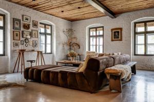 a large leather couch in a living room with windows at Darmyšl No13 in Staré Sedlo +61 photos