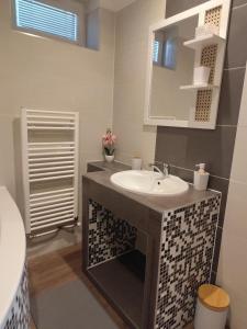 a bathroom with a sink and a mirror at Apartmán u Trojáků in Pozlovice +16 photos