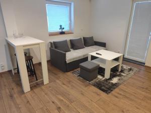 a living room with a couch and a table at Apartmán u Trojáků in Pozlovice