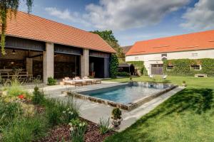 a backyard with a swimming pool and a house at Darmyšl No13 in Staré Sedlo