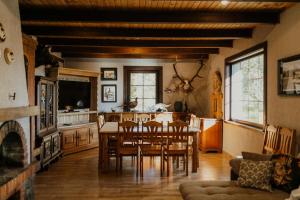 a kitchen and dining room with a table and chairs at Viesu nams Smēdes in Limbaži