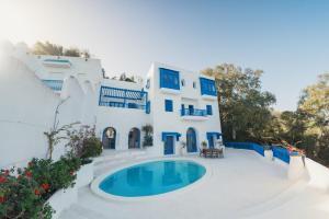 a house with a swimming pool in front of it at Villa Kahina in Carthage