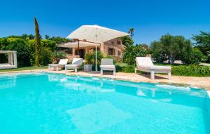 a swimming pool with chairs and an umbrella at Son Artigues in Manacor +44 photos