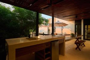 a kitchen with a sink and an umbrella on a patio at Hotel Compartir in Brisas de Zicatela