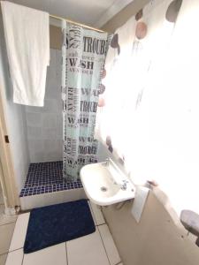 a bathroom with a sink and a shower at affordable room rustenburg in Kroondal