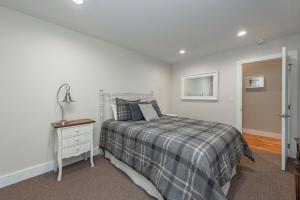 a bedroom with a bed and a dresser and a mirror at Wake Up Grateful by Railey Vacations in Swanton