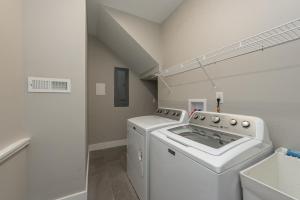 a laundry room with a washer and dryer at Wake Up Grateful by Railey Vacations in Swanton +32 photos