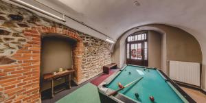 a pool table in a room with a brick wall at DJH Jugendherberge Görlitz Altstadt in Görlitz
