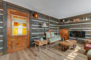 a living room with wood paneled walls and a door at auxportesdesMilleIles in Laval