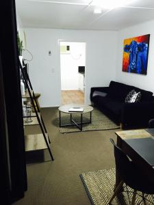 a living room with a couch and a table at Cottage on Cork Steadman Cottage in Winton